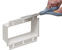 scissors removing removable flange on box extender