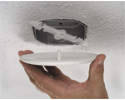 person installing ceiling box cover on popcorn ceiling