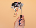 person installing fan bracket with screwdriver