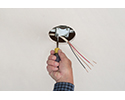 person tightening mounting bracket for pan box