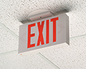 exit sign mounted to center of ceiling tile