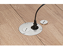 floor box in wooden floor with device plugged into receptacle