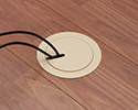 floor box in wooden floor with devices plugged in