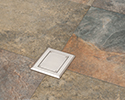 floor box in tiled floor with blank cover