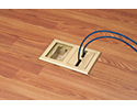two gang floor box in wooden floor with devices plugged in