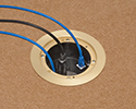 in-box recessed floor box with devices plugged in