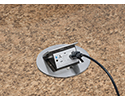 pop up countertop box in granite countertop with device plugged in