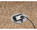 pop up countertop box in granite countertop with device plugged in