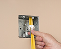 person installing push-in connector to box