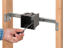 person tightening slider clip to secure two gang box